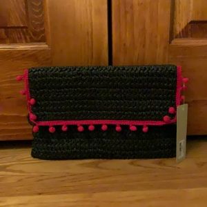 Black clutch purse with red tassels